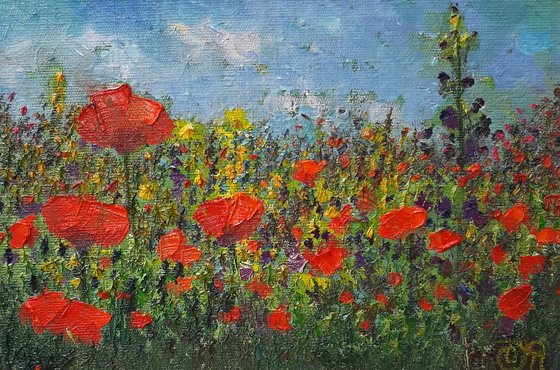 Landscape with red poppies