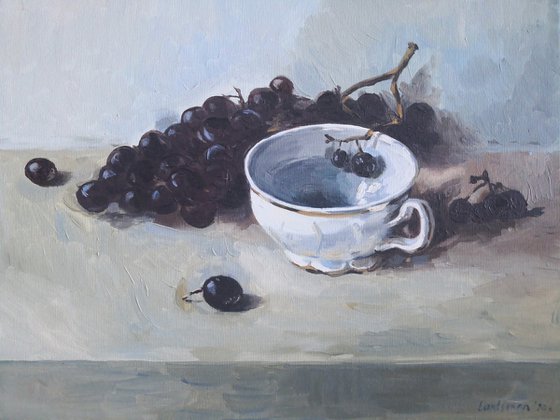 Black grapes and a porcelain cup still life