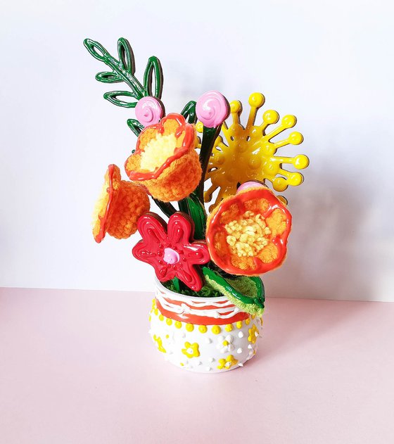 Orange crochet flowers in vase