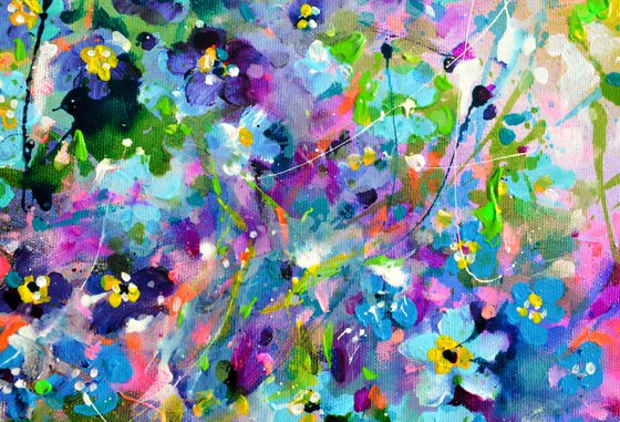 Forget me not flower field at sunrise