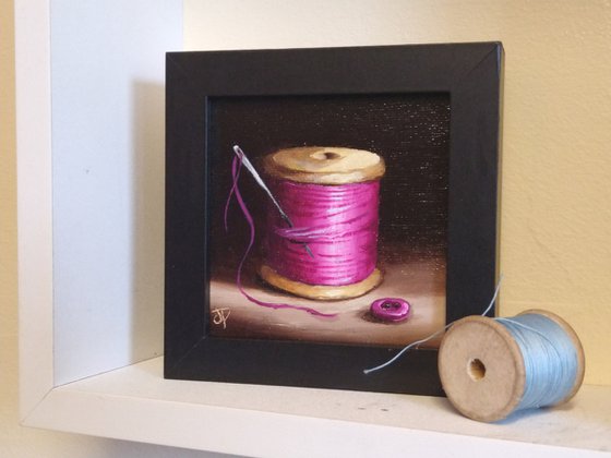 Little pink  cotton reel with button still life