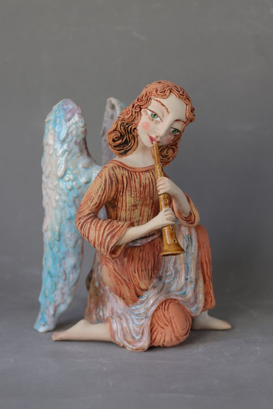 Sitting Angel with a flute. Ceramic OOAK sculpture.