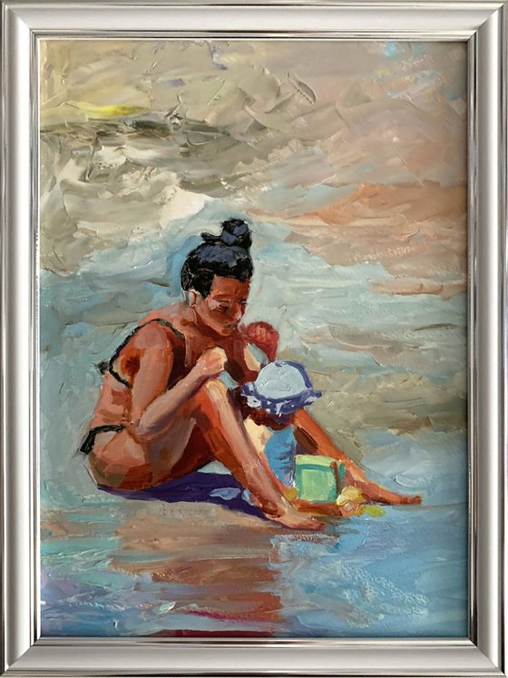 Mom with a kid on the beach.