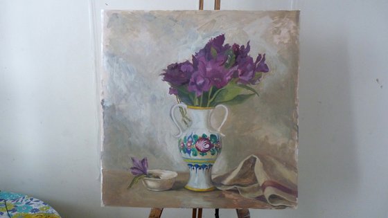 Purple flowers in a colorful jug