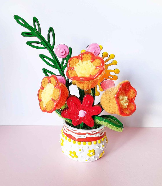 Orange crochet flowers in vase