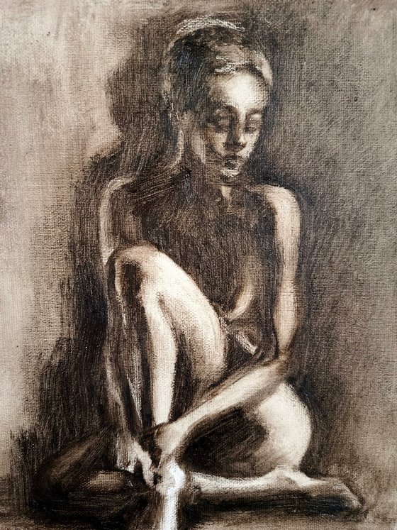 Nude woman sitting