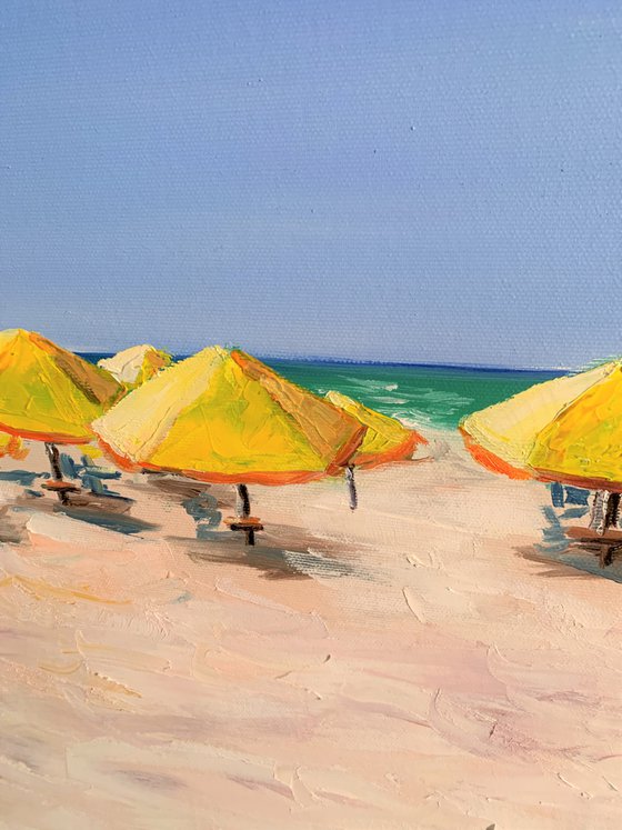 At the beach. Yellow parasols.