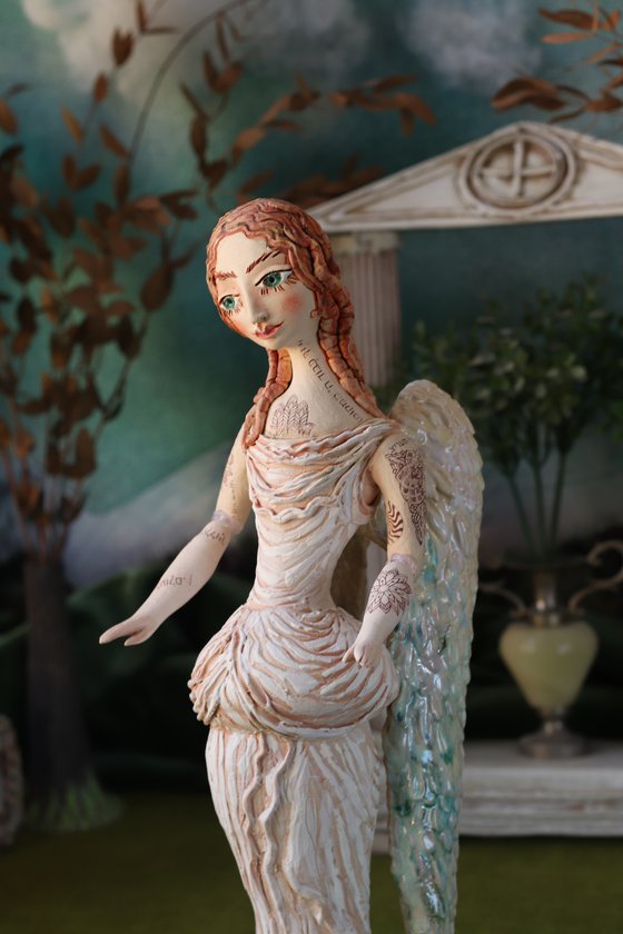 Angel with a tattoo. Ceramic OOAK sculpture.