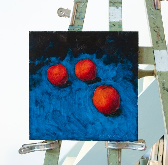 modern still life of peaches with blue background