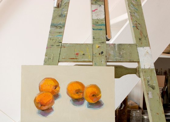 four apricots on white