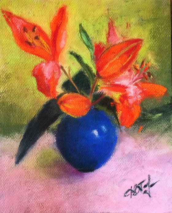 lilies in blue vase