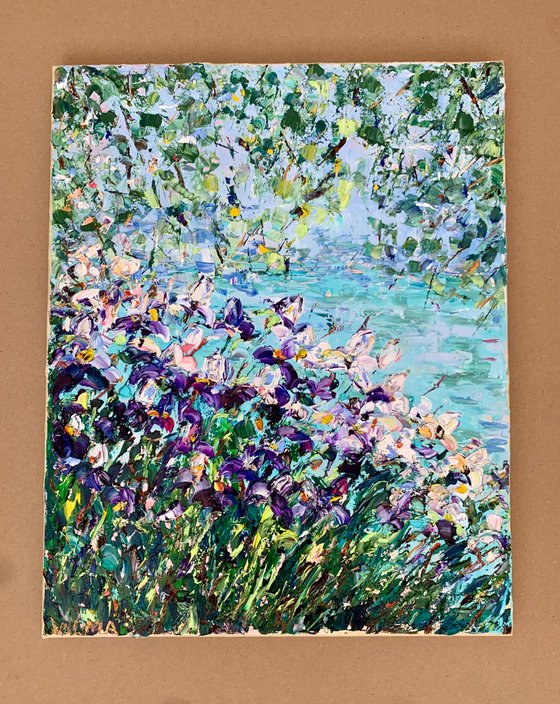 Blooming irises by the pond