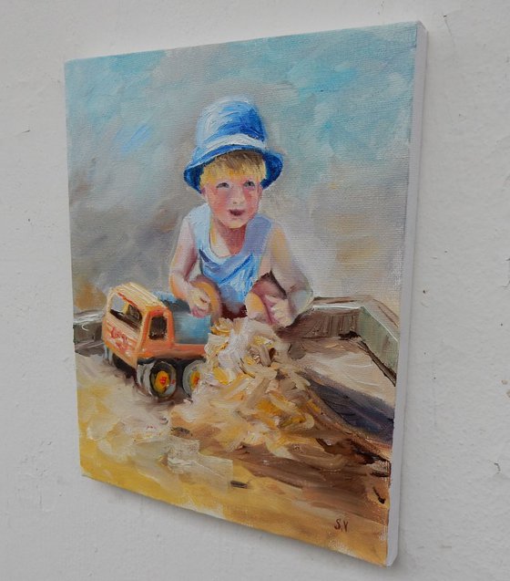 A boy plays in the sandbox. The series of paintings "Playing kids"
