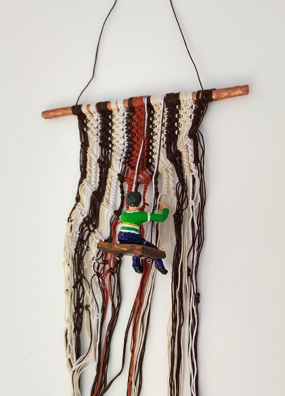 Boy on the macrame wall hanging