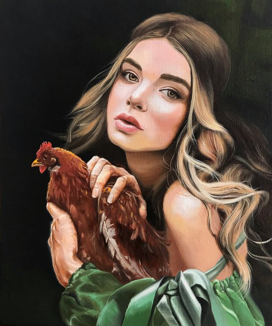 Girl with a chicken in her hands