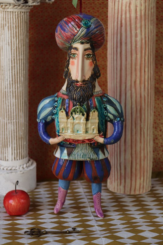 Oriental king holding a cathedral in his hands. Hanging sculpture, Bell-doll