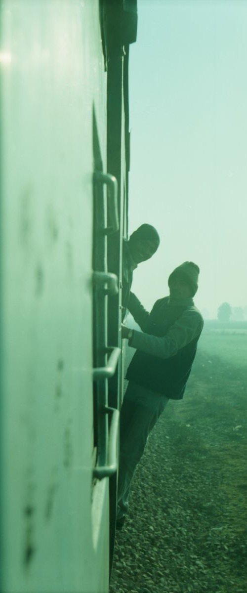 Travellers hanging off train by Nadia Attura