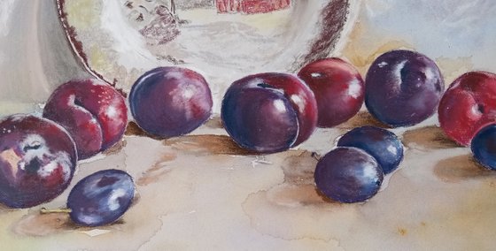 Plums rolled across the table