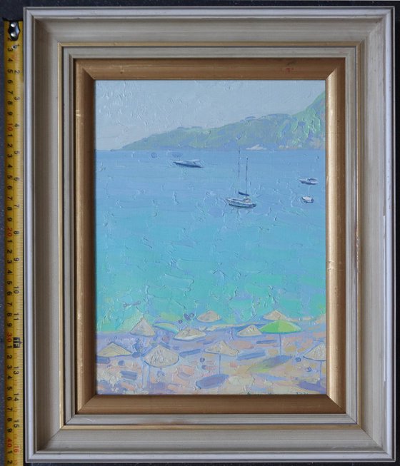 Yachts and umbrellas on the beach