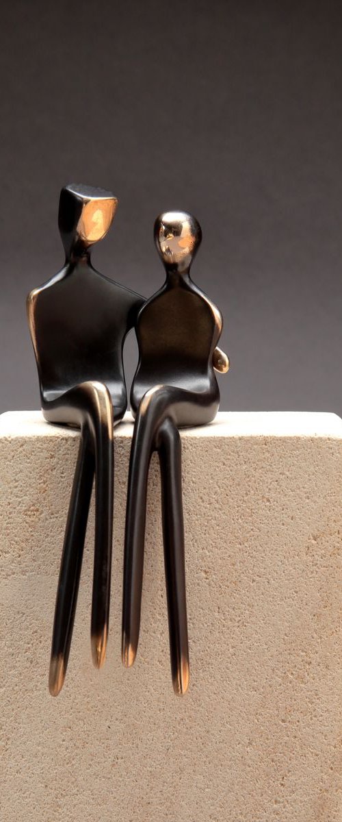 "Caress" a small bronze sculpture of a loving couple by Yenny Cocq