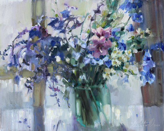 Blue wildflowers on window