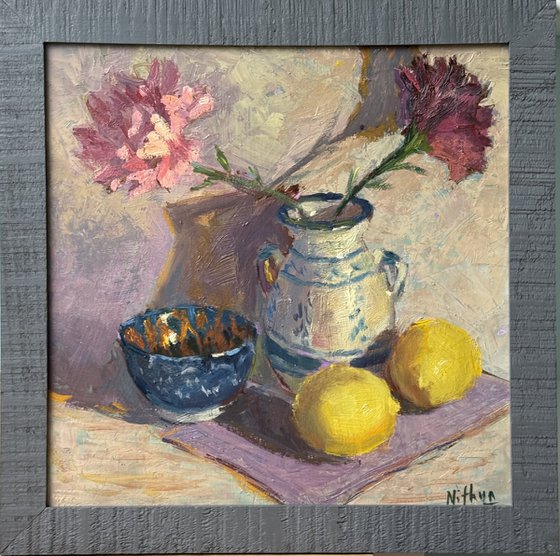 Lemons and flowers with a vase