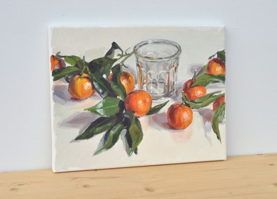 Clementines with leaves and old jam jar