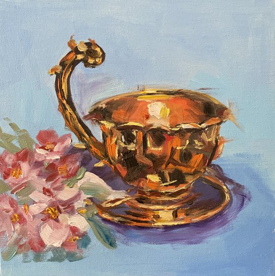Brass cup with flowers.