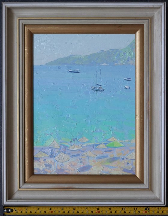 Yachts and umbrellas on the beach