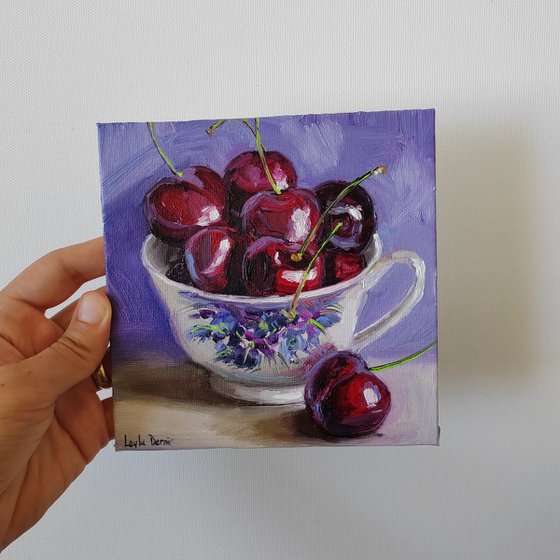 Cherries in porcelain cup