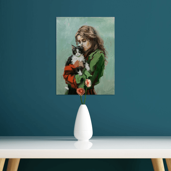 Girl in green dress with cat.