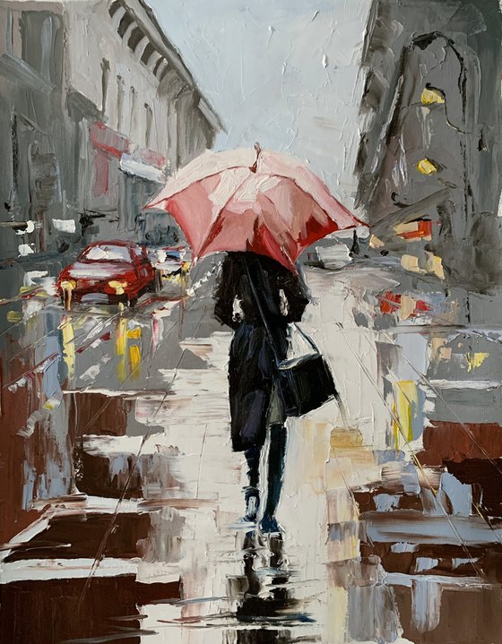 Woman with umbrella in a rainy city.