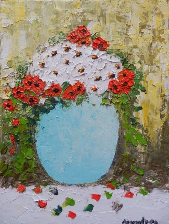Red and white flowers in a blue vase