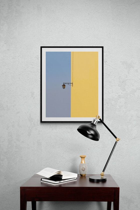 SIngle lamp on yellow wall