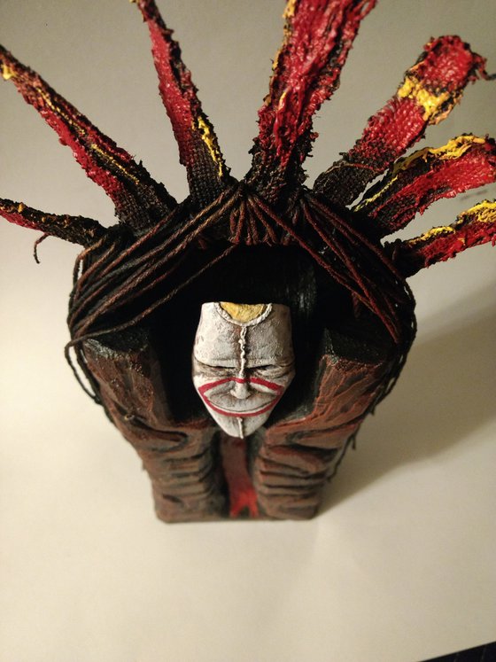 Mask of a smiling god. original sculpture