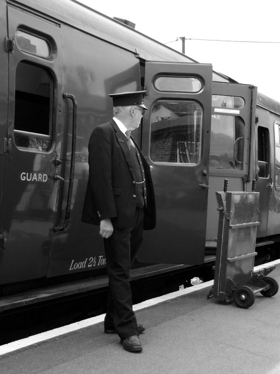 Station guard and steam train carriage