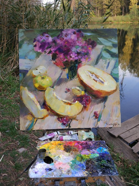 Still life with melon on the background of the lake