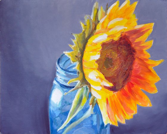 Yellow sunflower in a blue jar