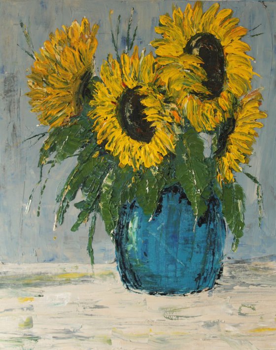 Sunflowers in blue pot.