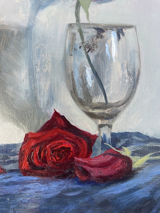 Red rose in empty glass