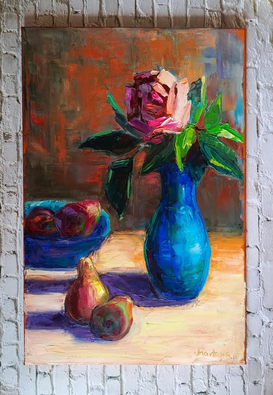 Red rose in a blue vase