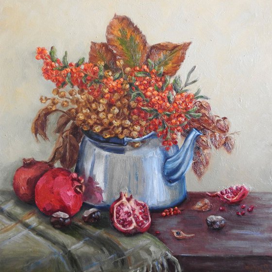 Still life with teapot, pomegranate, autumn leaves and seeds