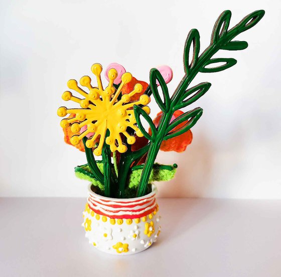 Orange crochet flowers in vase