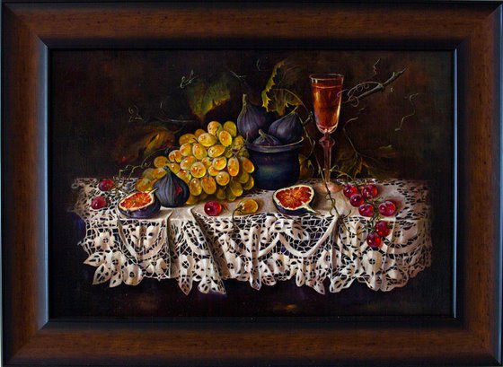 Still life with grapes and figs on a lace tablecloth