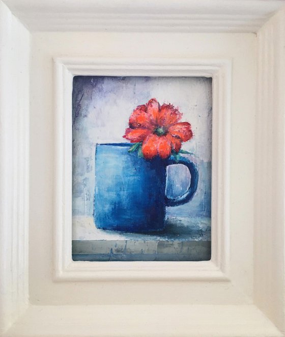 Orange Flower in Blue Mug.