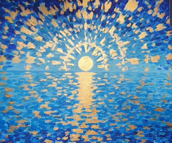 Sunrise over the ocean in blue and gold