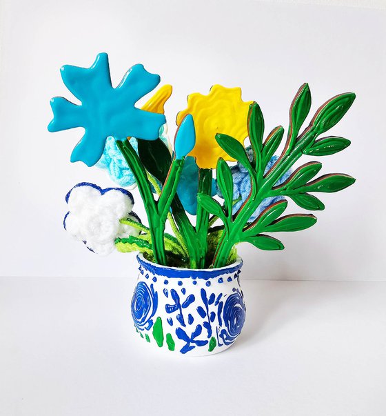 Blue crochet flowers in vase