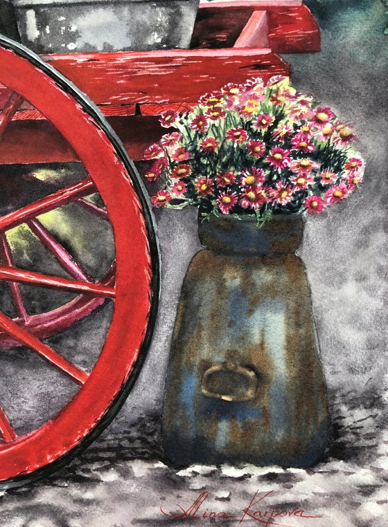 Old red cart with flowers