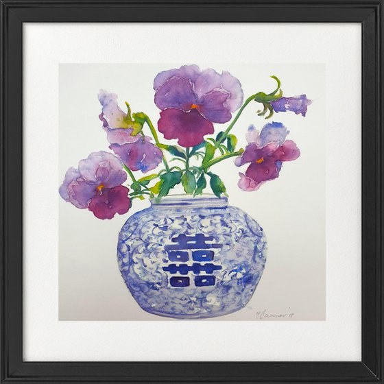 Purple pansies in a blue & white vase