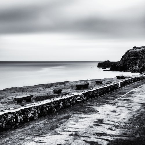 Benches on the road along the west coast by Karim Carella